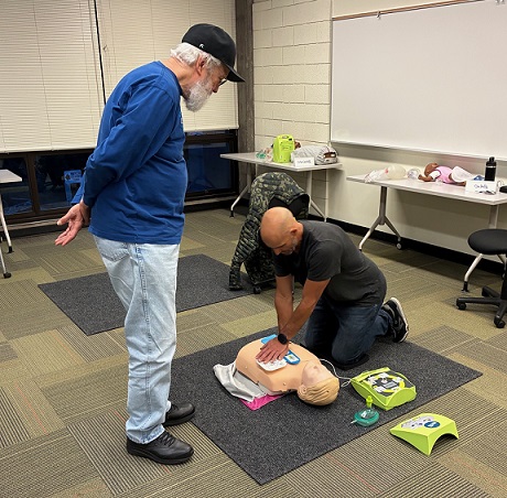 CPR student practicing chest compressions