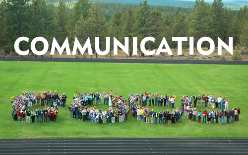 COCC employees spelling out COCC on Mazama Field