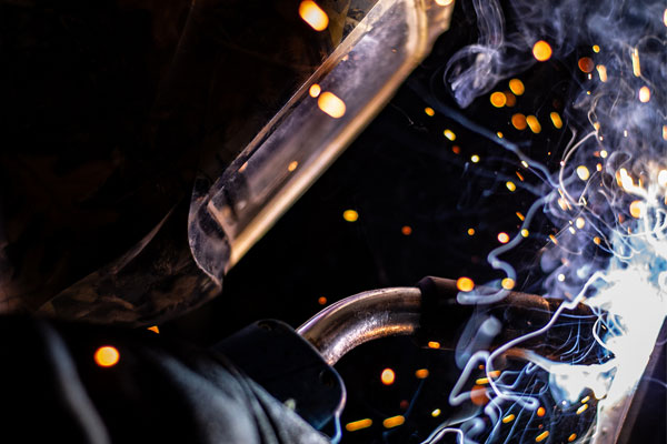 Welding close up with sparks and welder mask